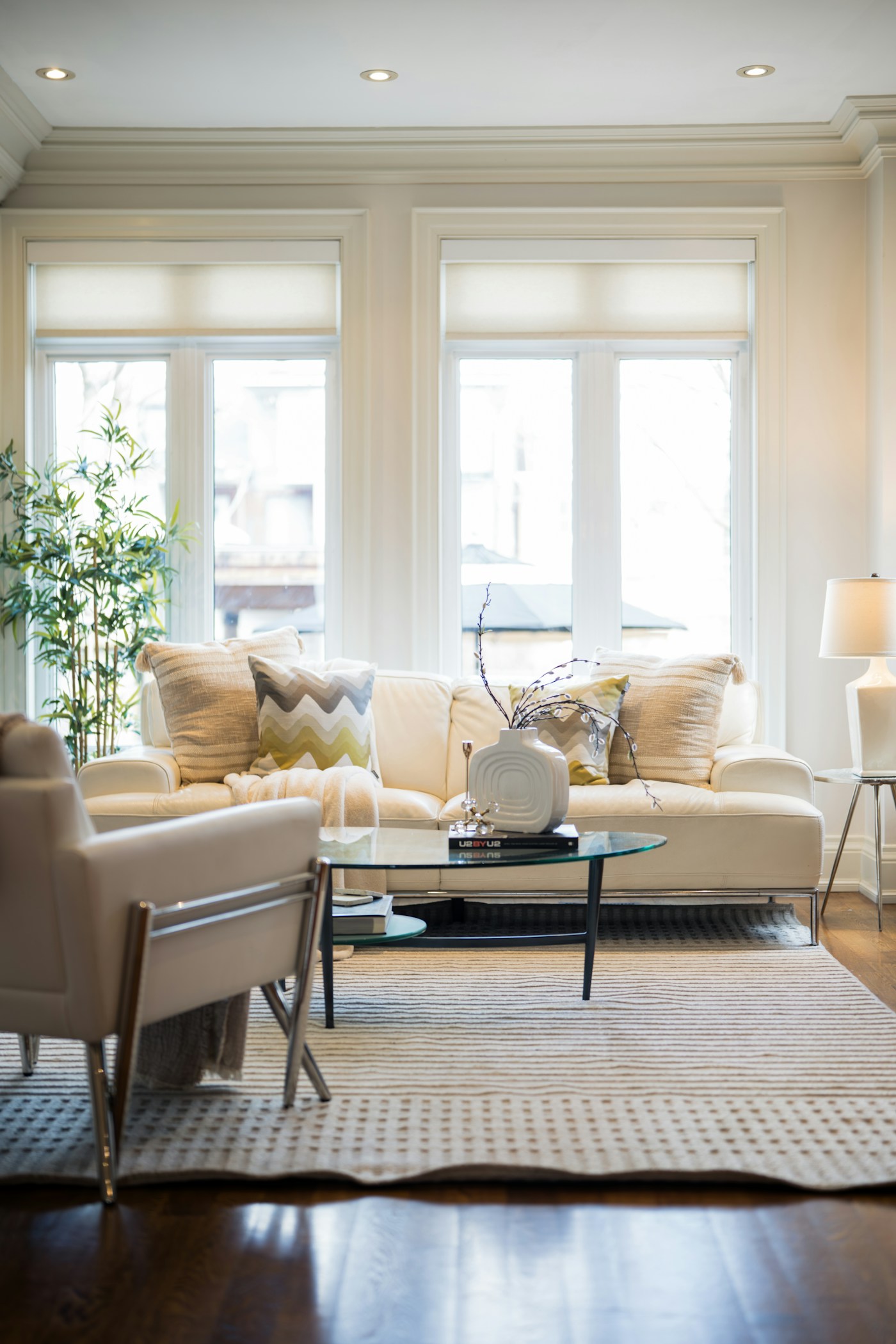 Sunlit living room with a cream sofa, houseplants and natural materials